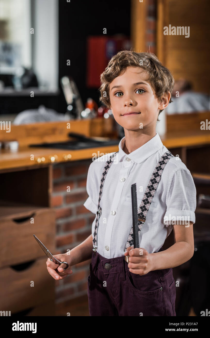 stylish little kid with scissors and comb at Stock Photo Alamy