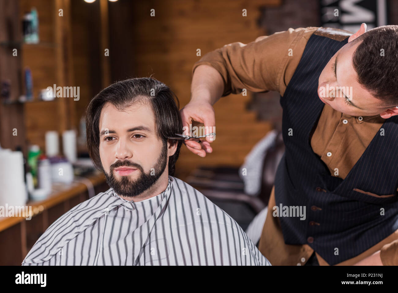 Handsome Young Man Getting Haircut From Professional Barber At