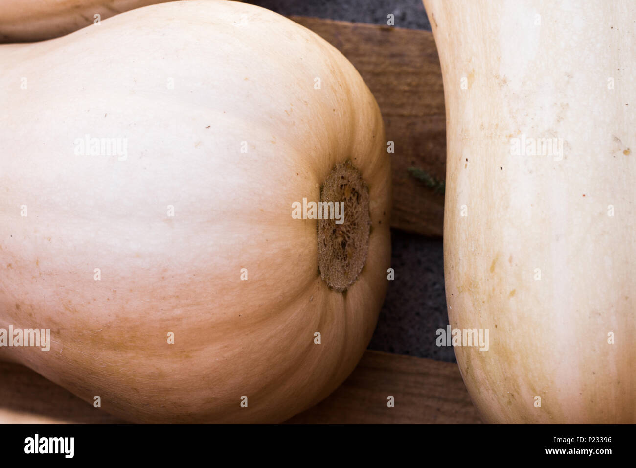 Close up detail of Butternut squash in a rustic wooden crate. Stock Photo