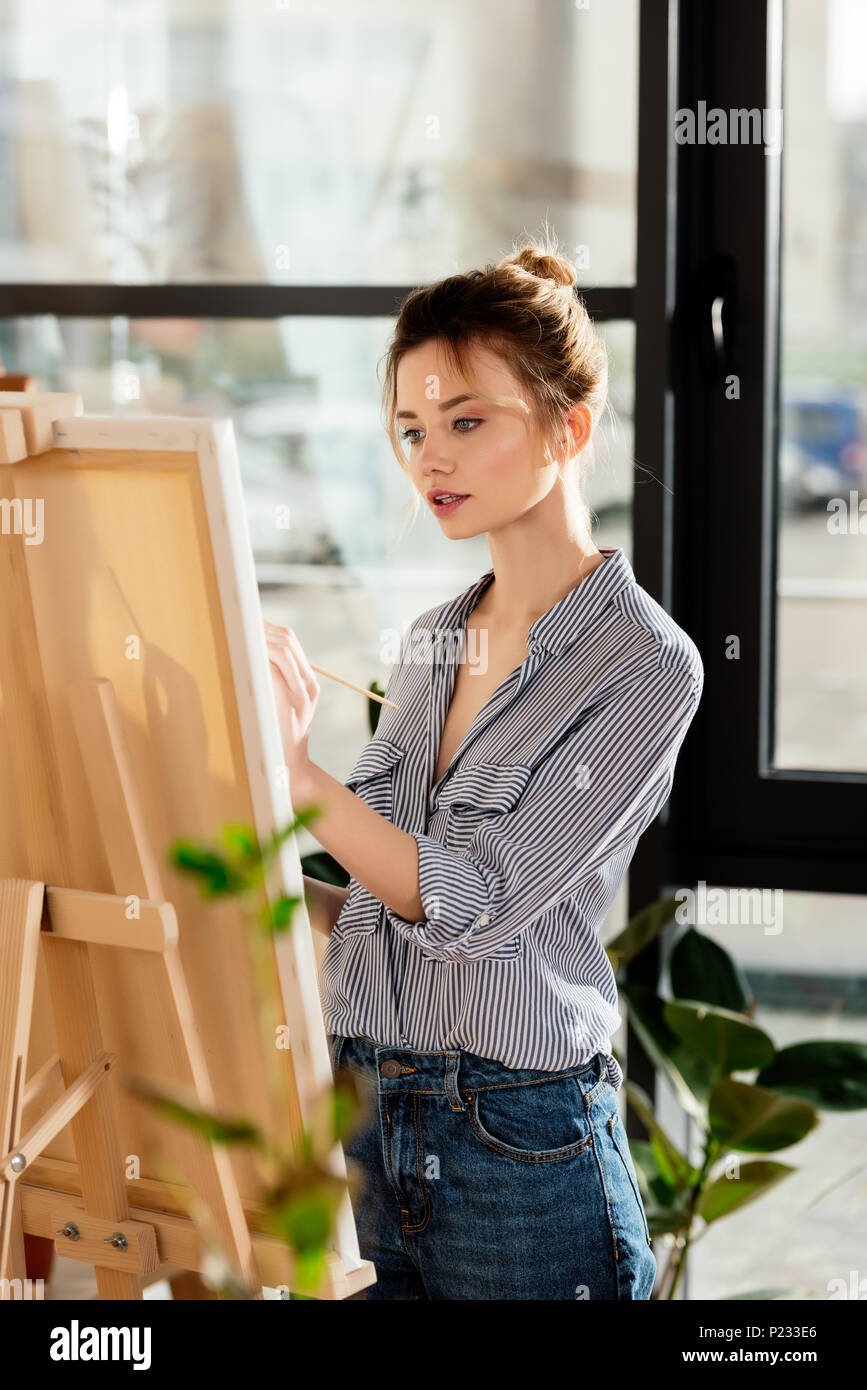 young attractive female artist drawing picture in studio Stock Photo ...