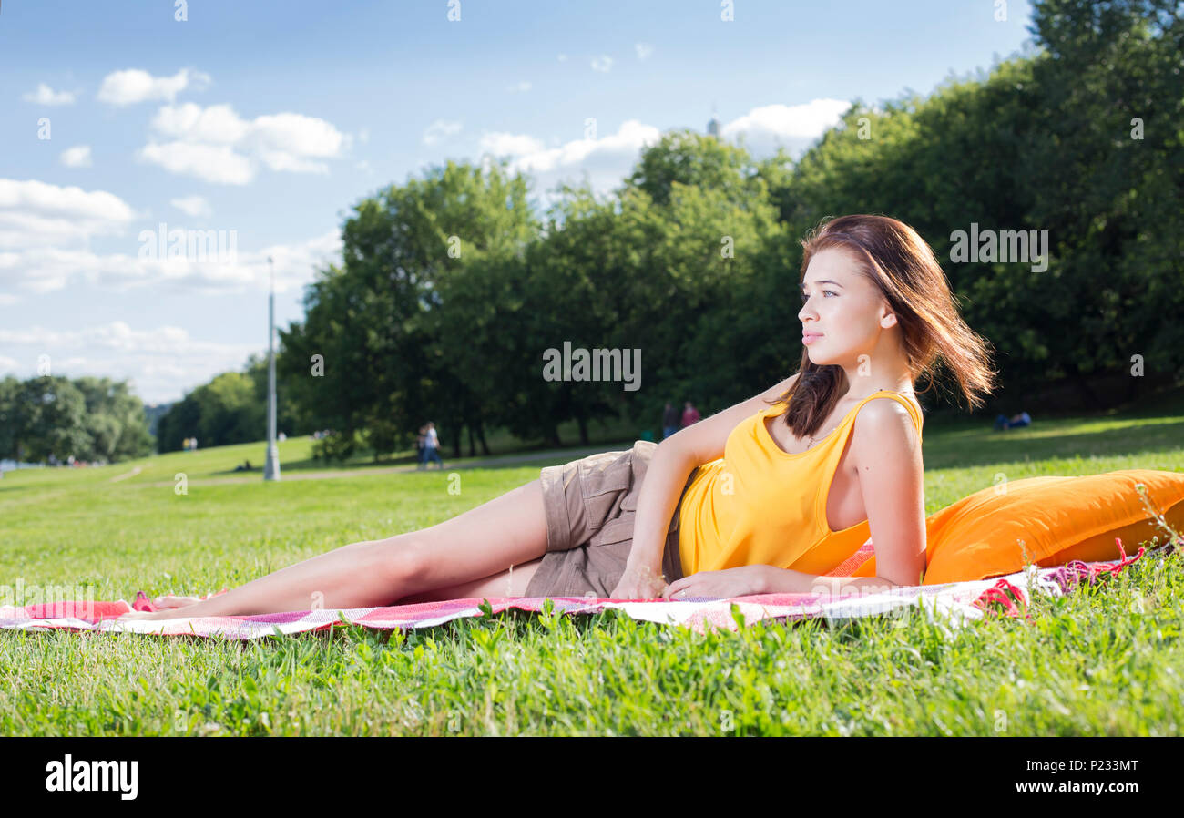 Young woman relaxing in a park Stock Photo - Alamy
