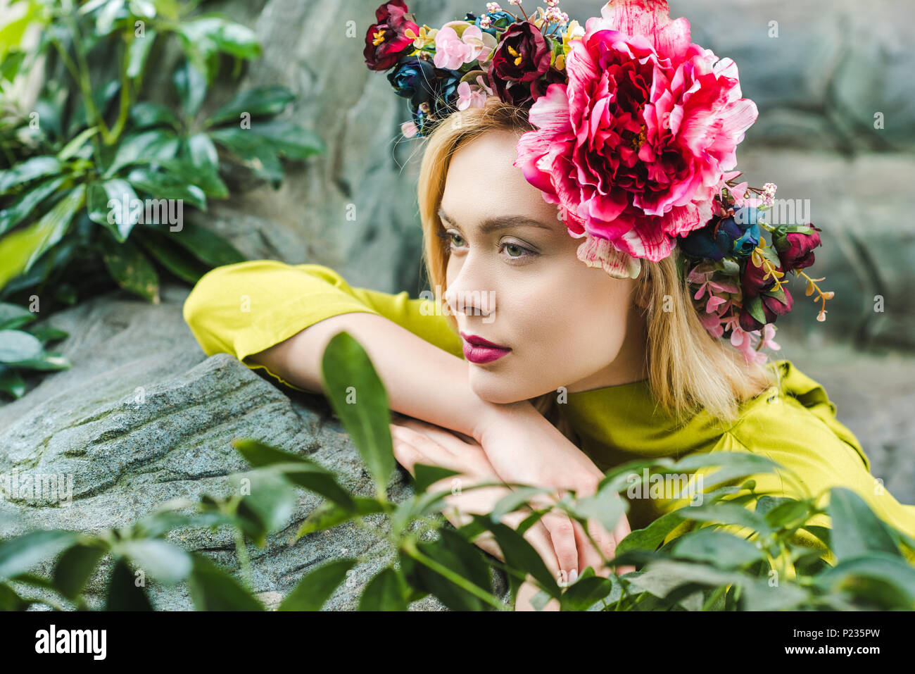 Woman leaning on rocks hi-res stock photography and images - Alamy