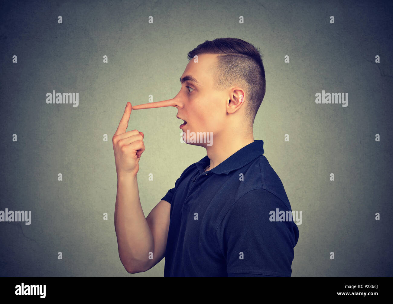 Liar man with long nose isolated on gray background. Stock Photo