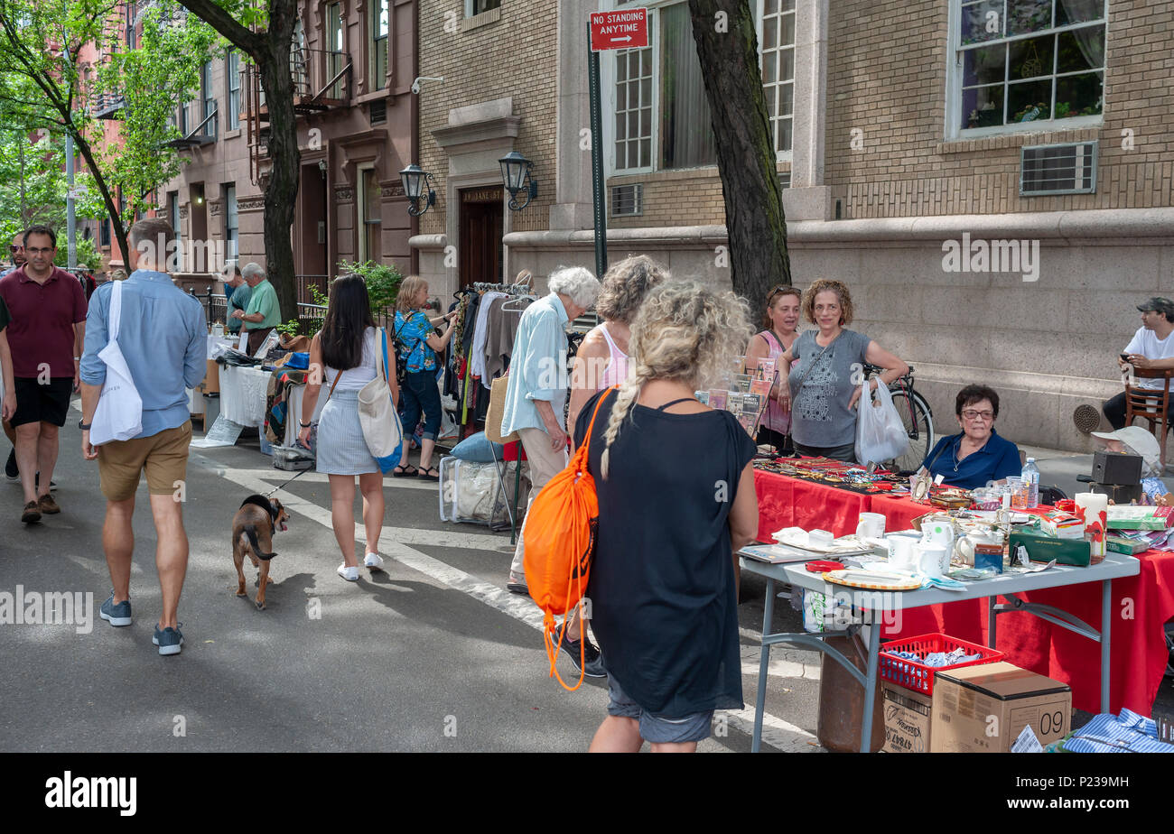 Shoppers search for bargains at the Jane Street Block Association Flea Market in the New York neighborhood of Greenwich Village on Saturday, June 2, 2018. The residents of Jane Street cleaned out their closets for their flea market.  (© Richard B. Levine) Stock Photo