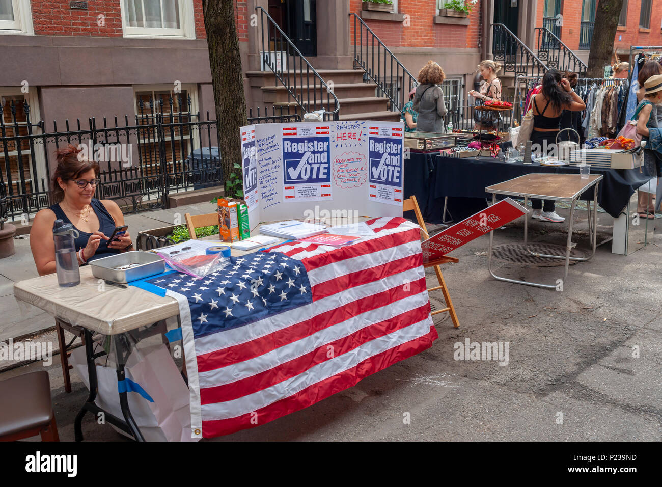 Voter registration table at the Jane Street Block Association Flea Market in the New York neighborhood of Greenwich Village on Saturday, June 2, 2018. The residents of Jane Street cleaned out their closets for their flea market.  (Â© Richard B. Levine) Stock Photo