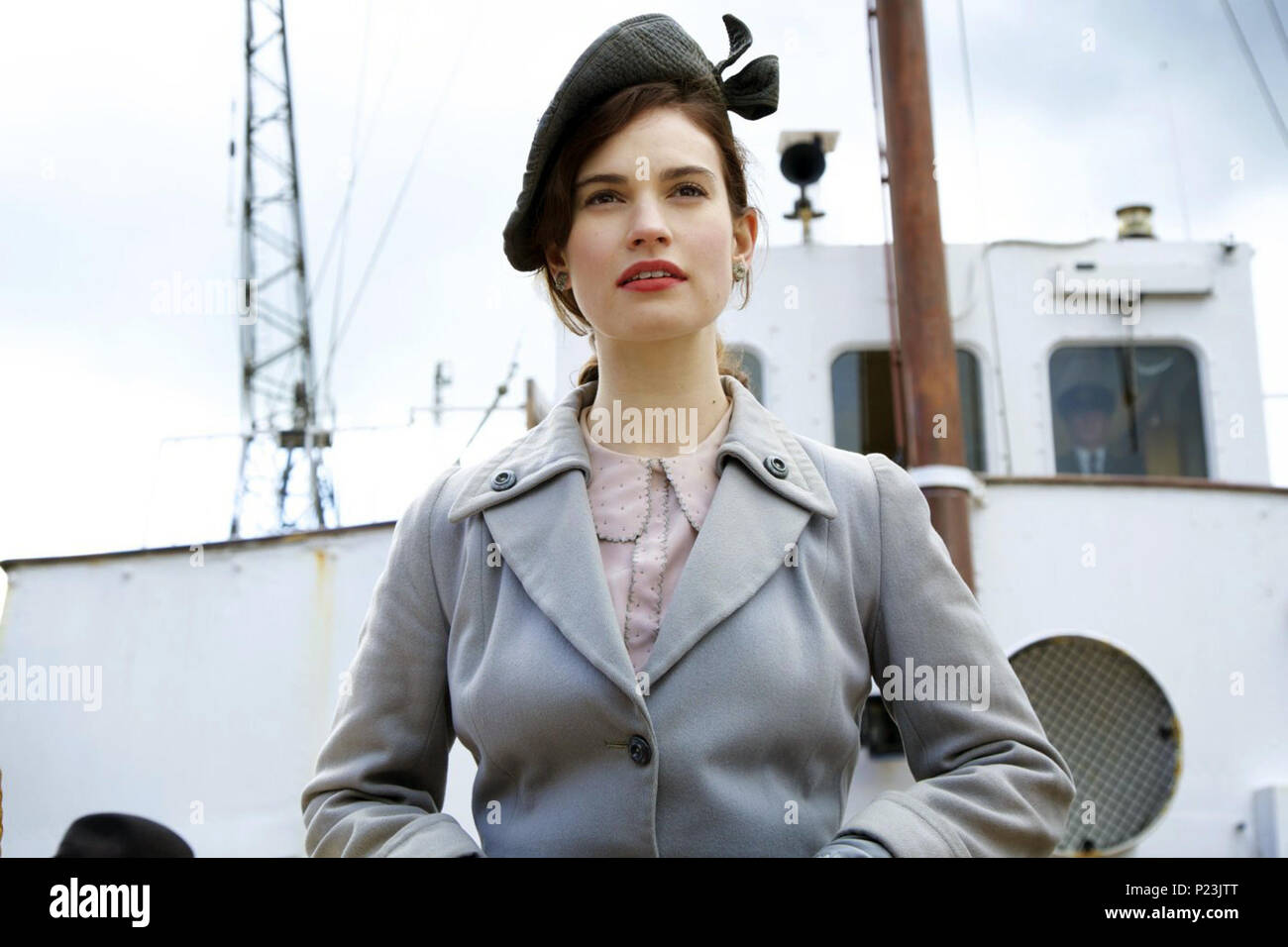 The Guernsey Literary and Potato Peel Pie Society is a British historical drama directed by Mike Newell and written by Don Roos and Tom Bezucha. The film is based on the 2008 novel of the same name, written by Mary Ann Shaffer and Annie Barrows.   This photograph is for editorial use only and is the copyright of the film company and/or the photographer assigned by the film or production company and can only be reproduced by publications in conjunction with the promotion of the above Film. A Mandatory Credit to the film company is required. The Photographer should also be credited when known. Stock Photo