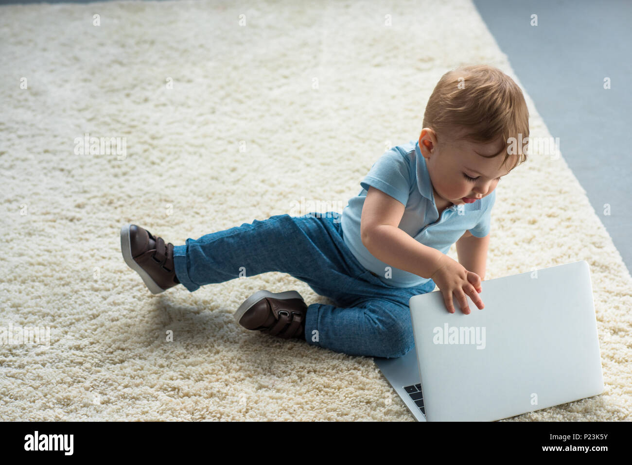 little baby boy with laptop sitting on floor at home Stock Photo - Alamy