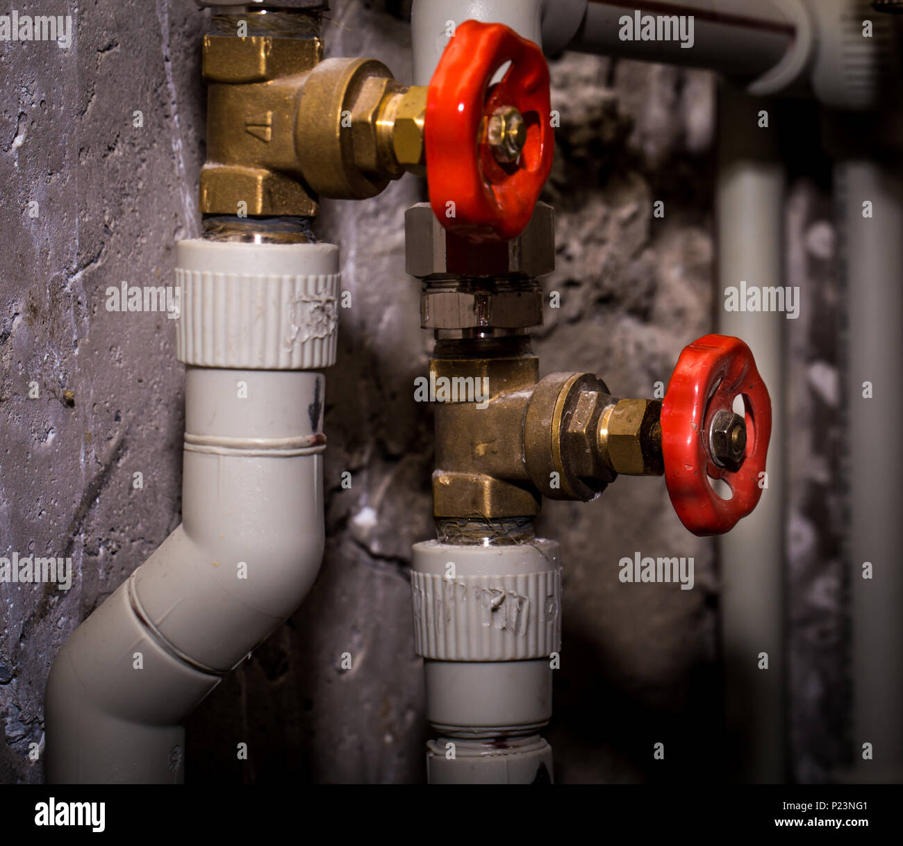 Piping with taps, Central heating system closeup Stock Photo Alamy