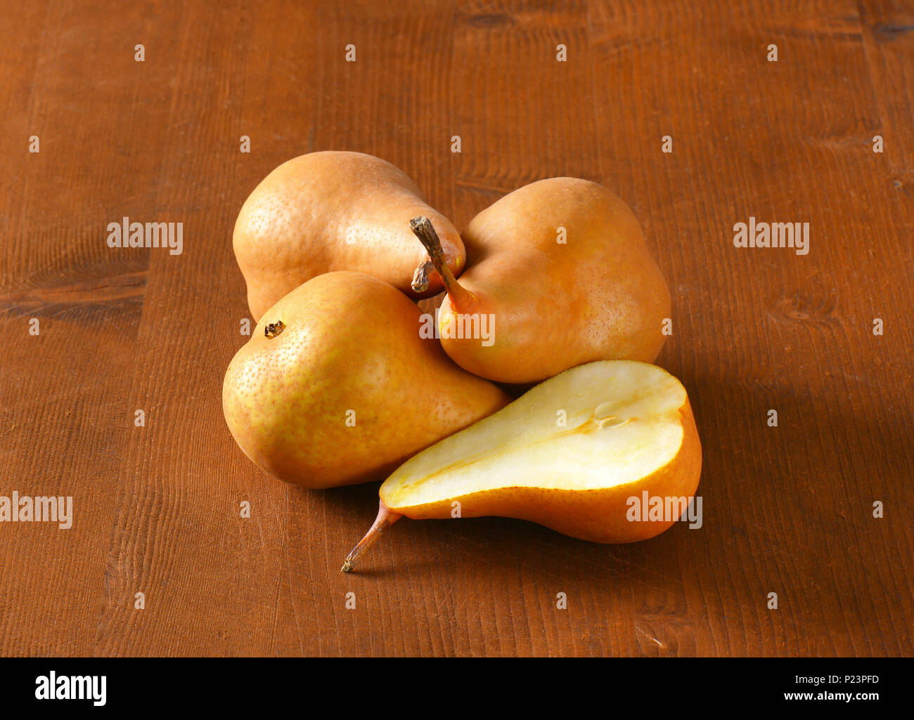 ripe bosc pears on wooden table Stock Photo
