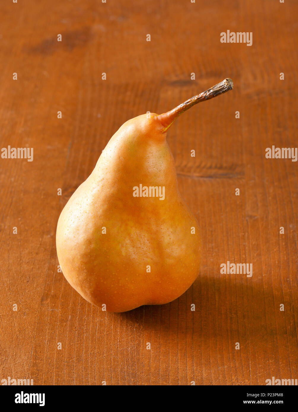 ripe bosc pear on wooden table Stock Photo