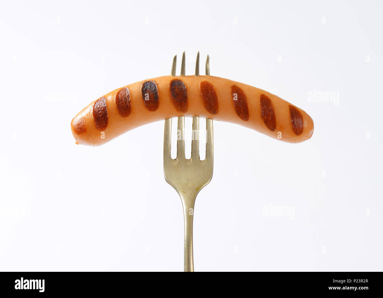 close up of grilled wiener sausage impaled on fork Stock Photo