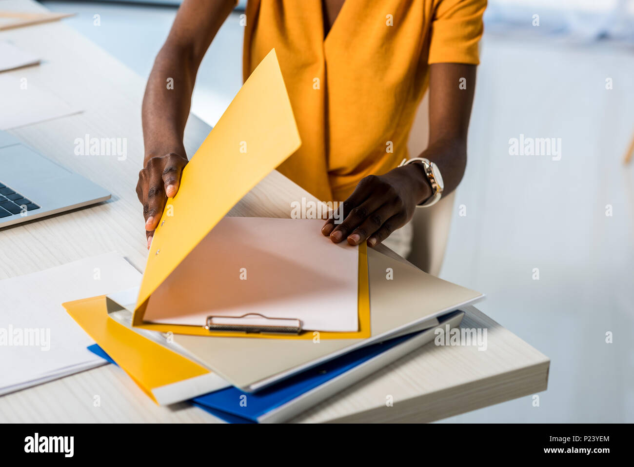 cropped shot of african american woman with folders remote working at home office Stock Photo