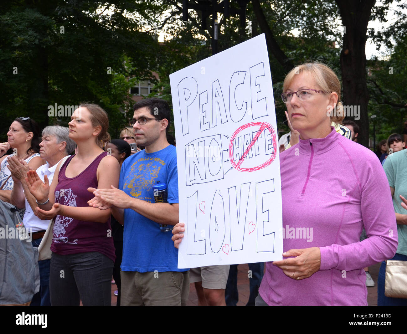 ANN ARBOR, MI - AUG 13: A woman holds up a sign at a rally in solidarity with the counter-protesters of Charlottesville, VA in Ann Arbor, MI on August Stock Photo