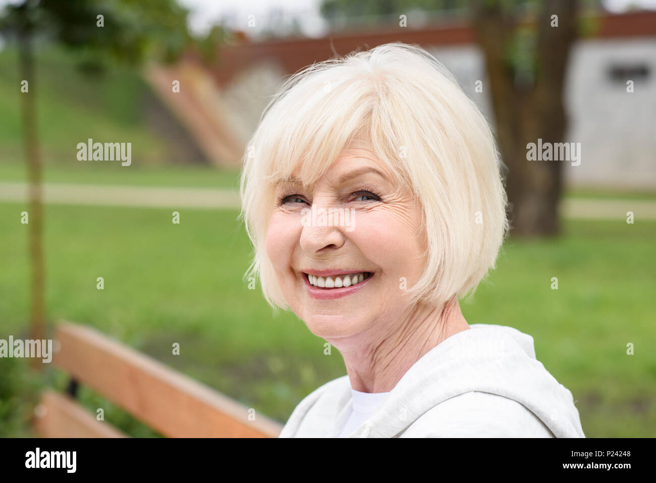 Cheerful senior woman sitting hi-res stock photography and images - Alamy