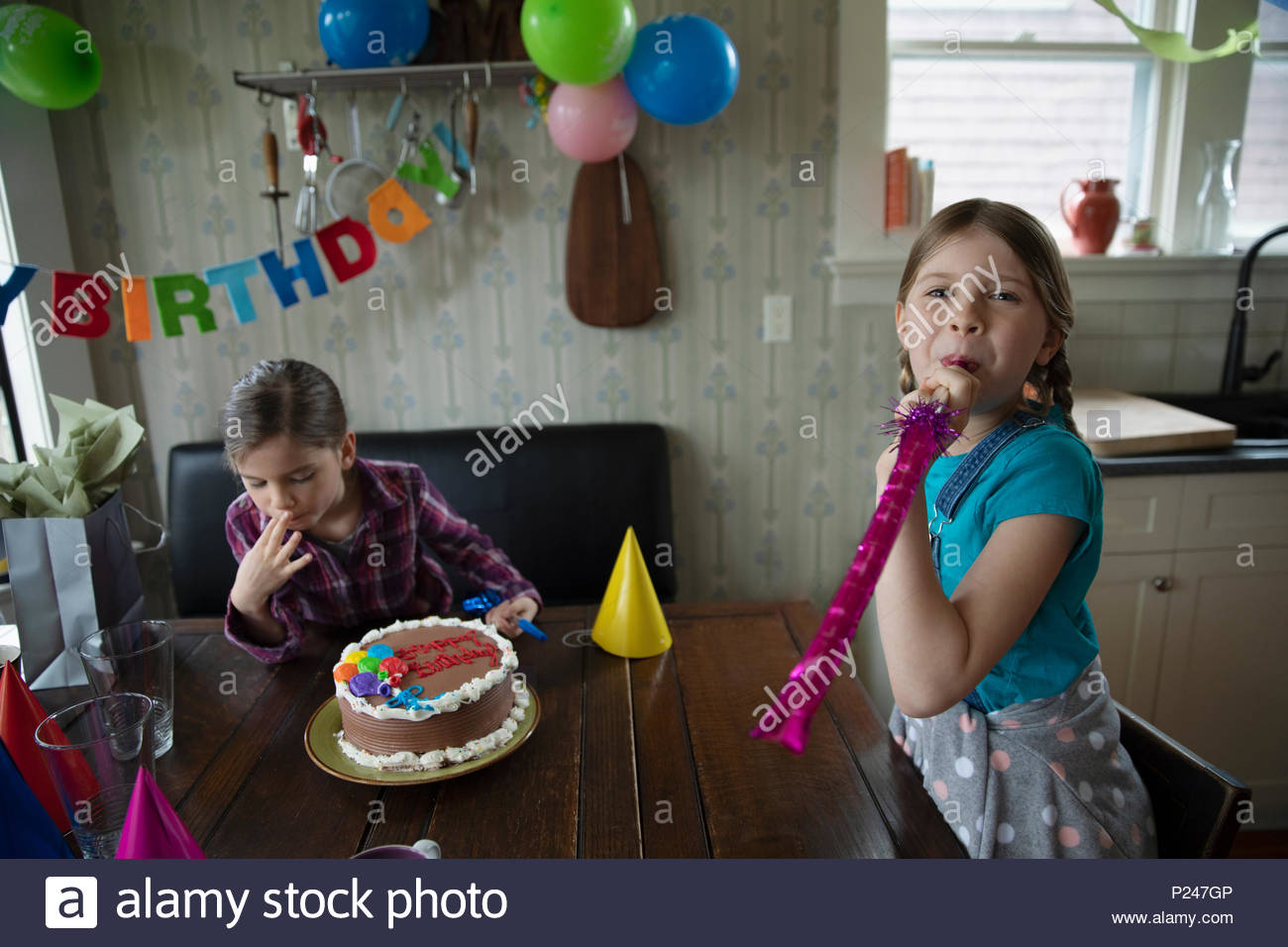 Portrait playful sisters celebrating birthday party Stock Photo Alamy