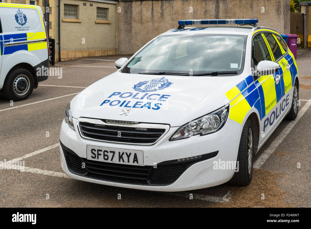 Police Scotland police car and log with name in Gaelic - Poileas Stock Photo