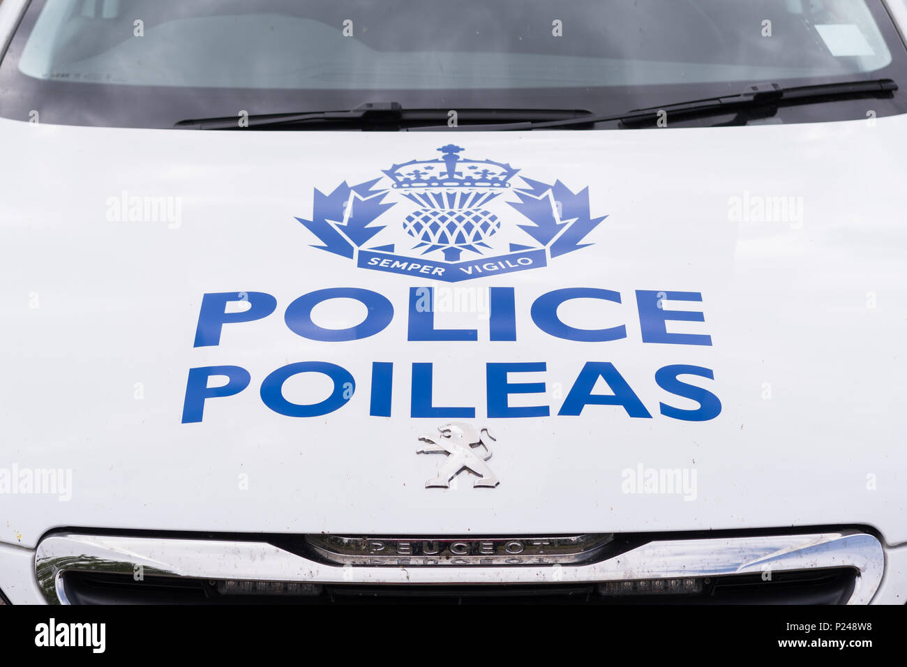 Police Scotland police car and logo with name in Gaelic - Poileas Stock Photo