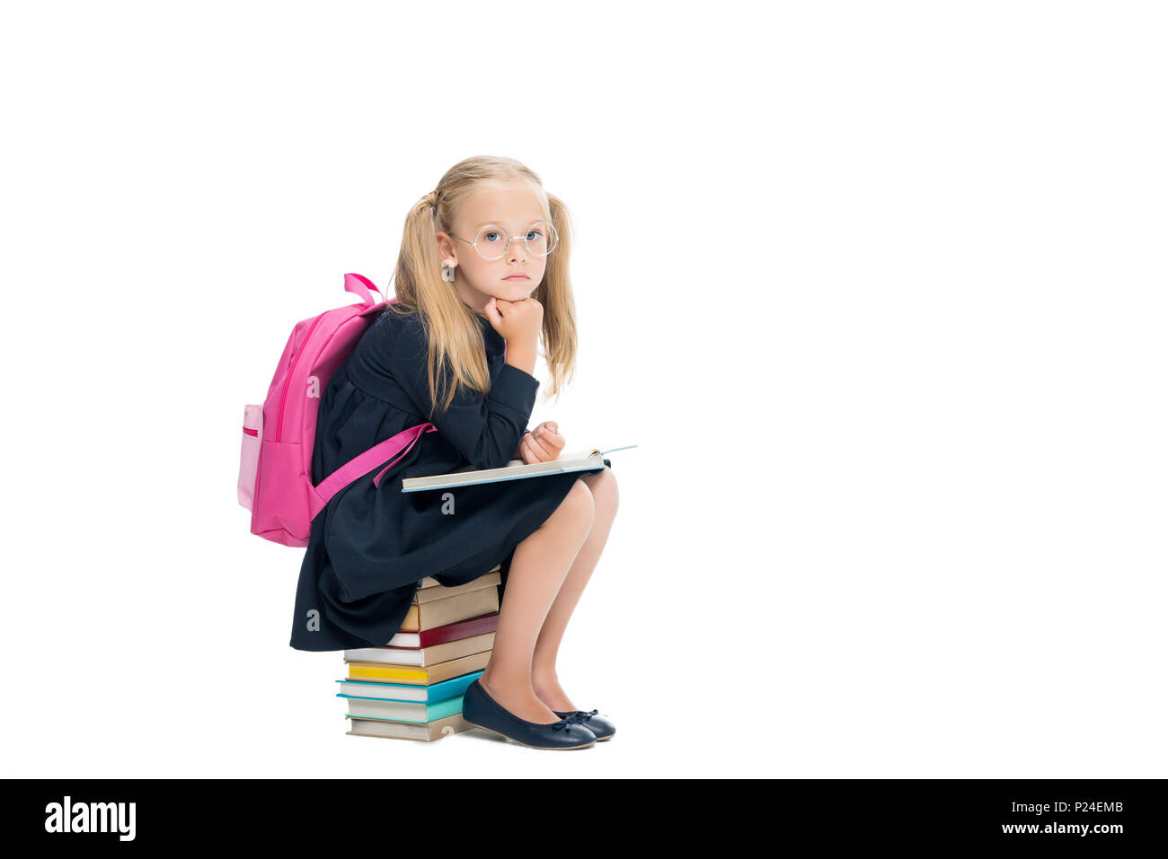 happy schoolgirl sitting on stack of books isolated on white Stock ...