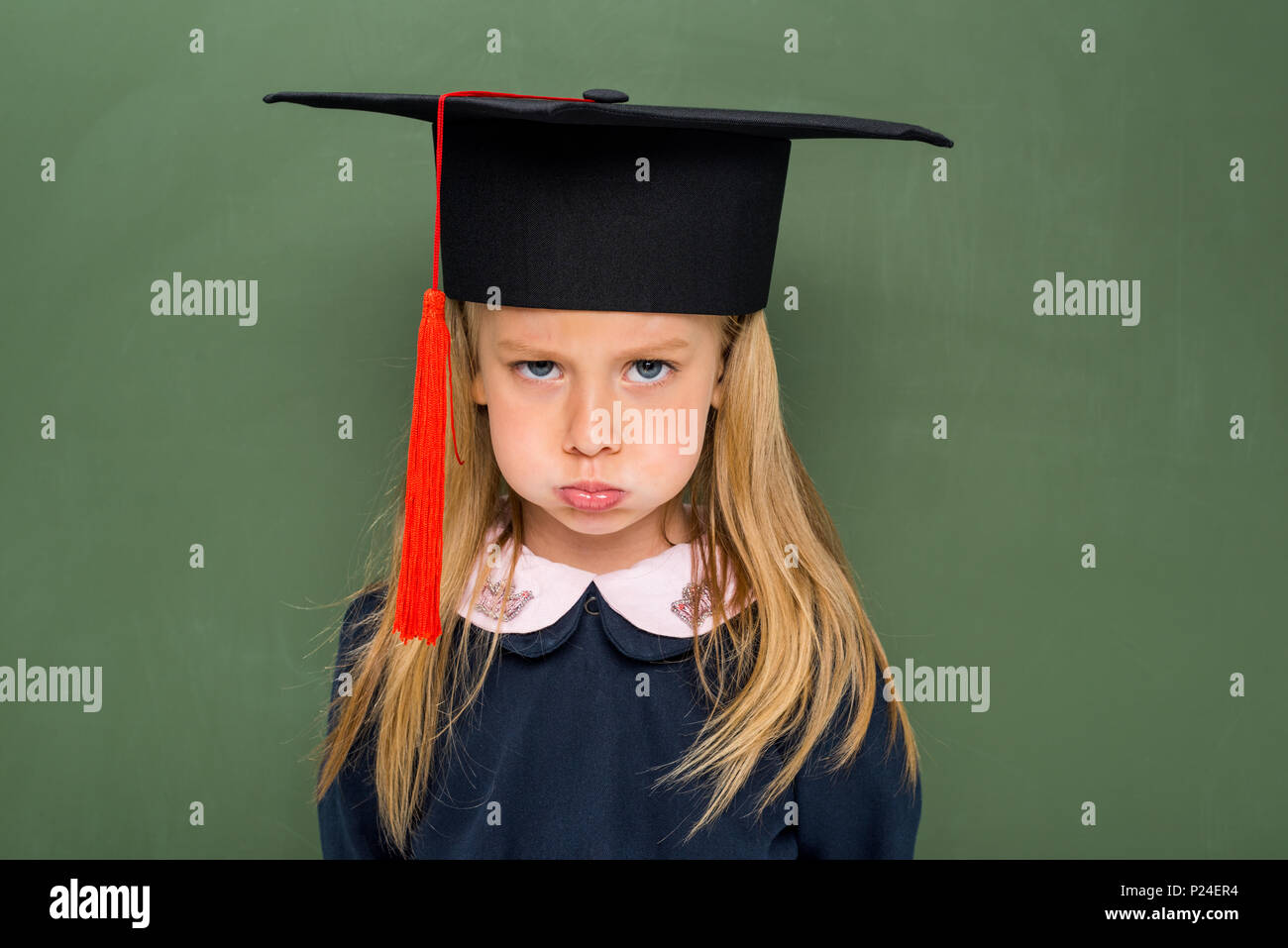 sad schoolgirl in graduation hat next 