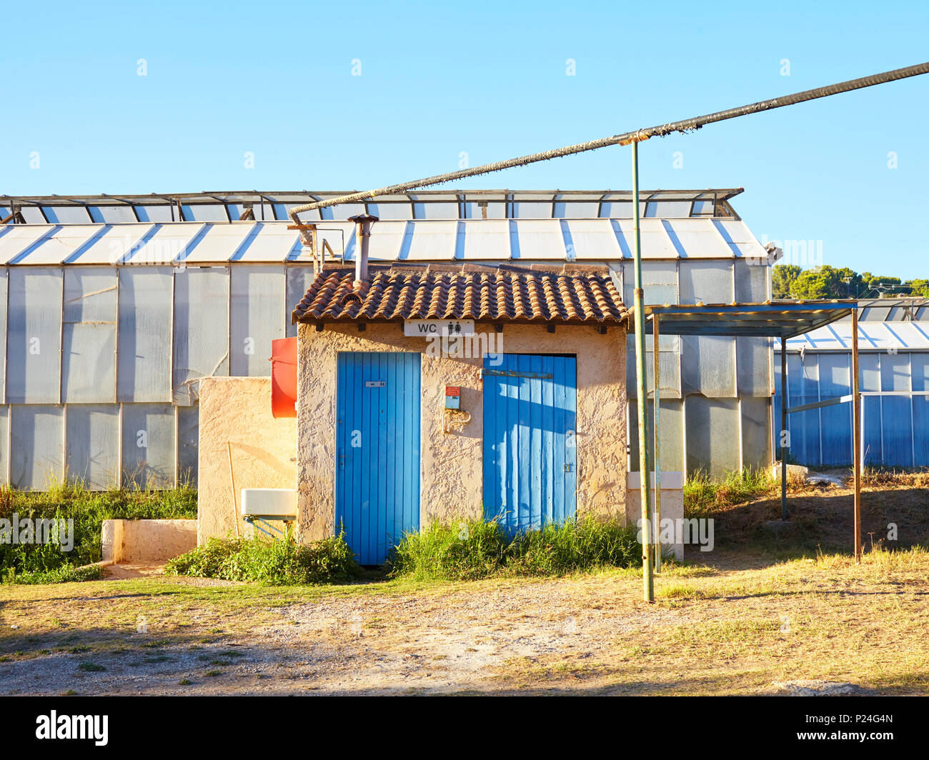 Toilet houses on a camping site in the south of France with cloudless heaven Stock Photo