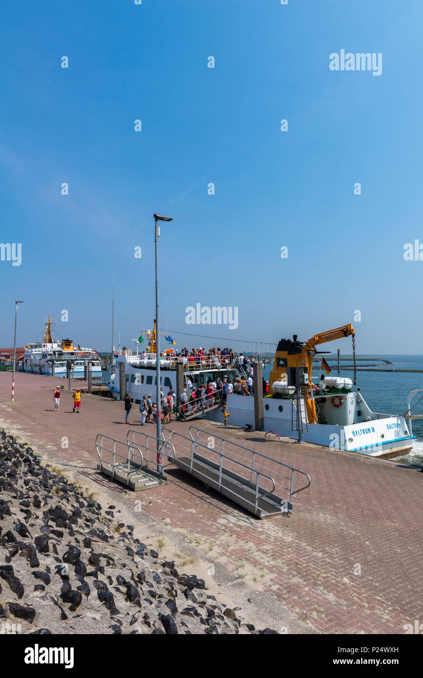 Tourists entering the ferry boat to the North Sea island of Baltrum,  Neßmersiel, East Frisia, Ostfriesland, Lower Saxony, Niedersachsen, Deutschland Stock Photo