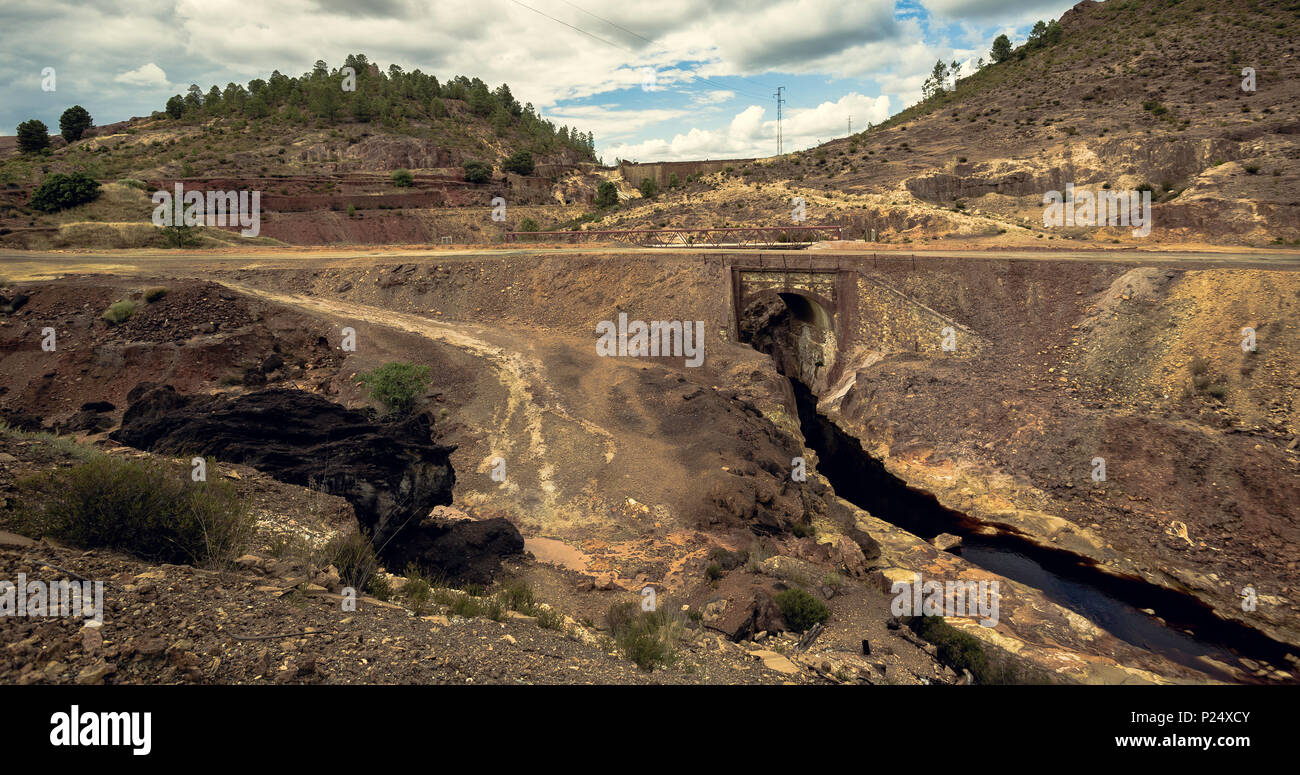 Big black rock and stone bridge in the mining complex of Zaranda, Spain Stock Photo