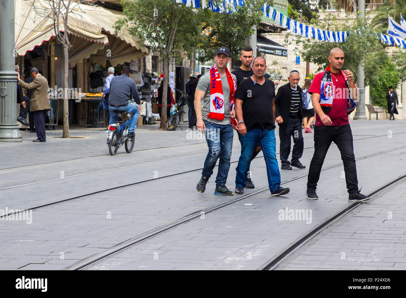 9 May 2013 A group of Hapoel football team supporters crossing Jaffa street in Jerusalem Israel before their match with Beitar Jerusalam Stock Photo