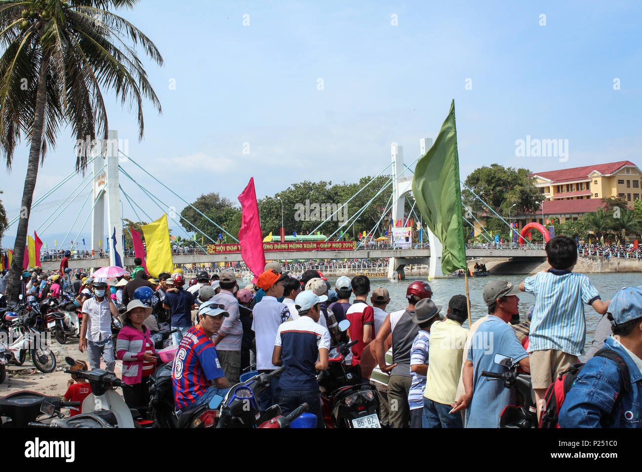 Phan Thiet , Vietnam - January 2014: Many people  during traditional dragon boat race during new year in Phan Thiet  , Vietnam Stock Photo