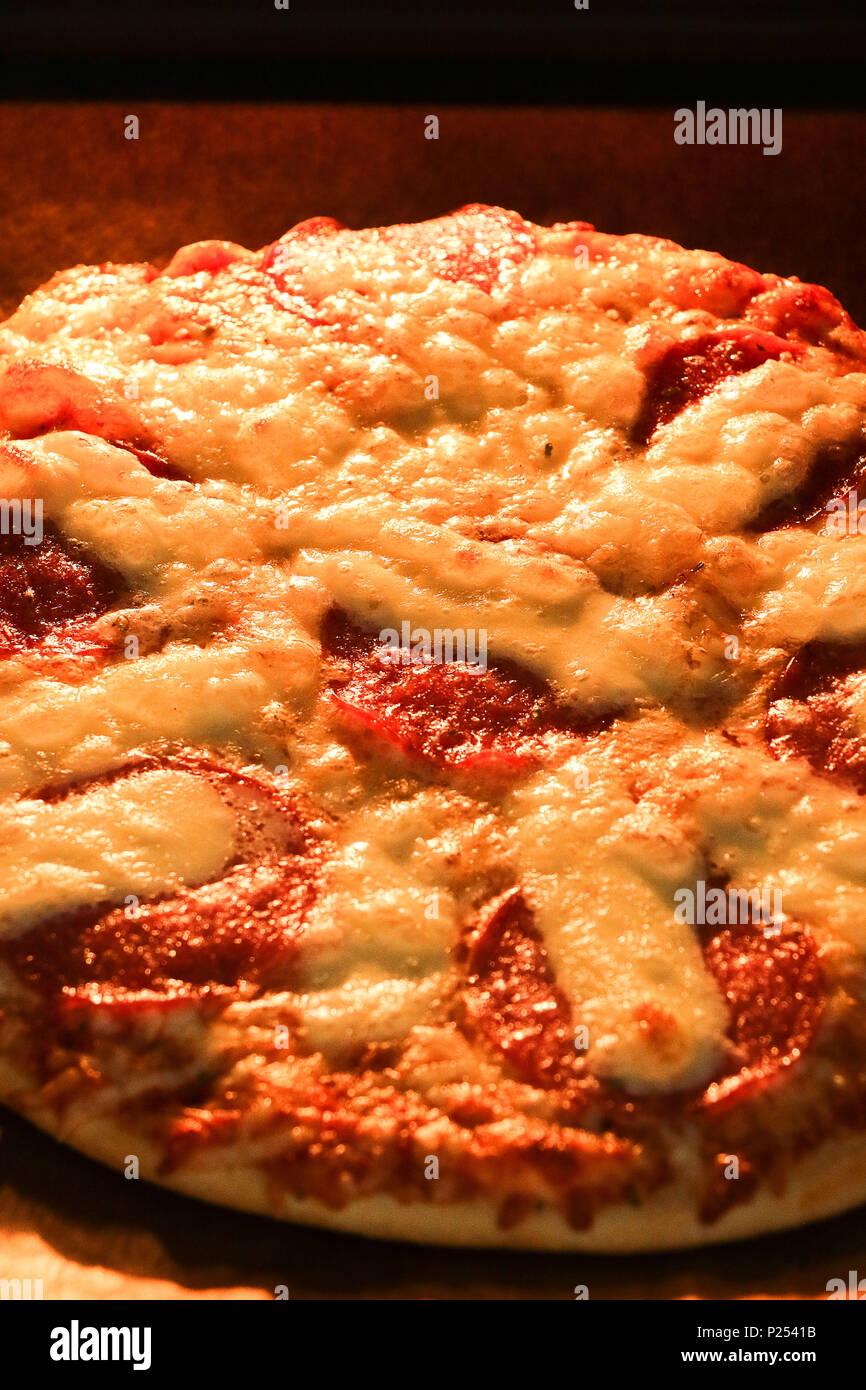 Pizza in the oven Stock Photo