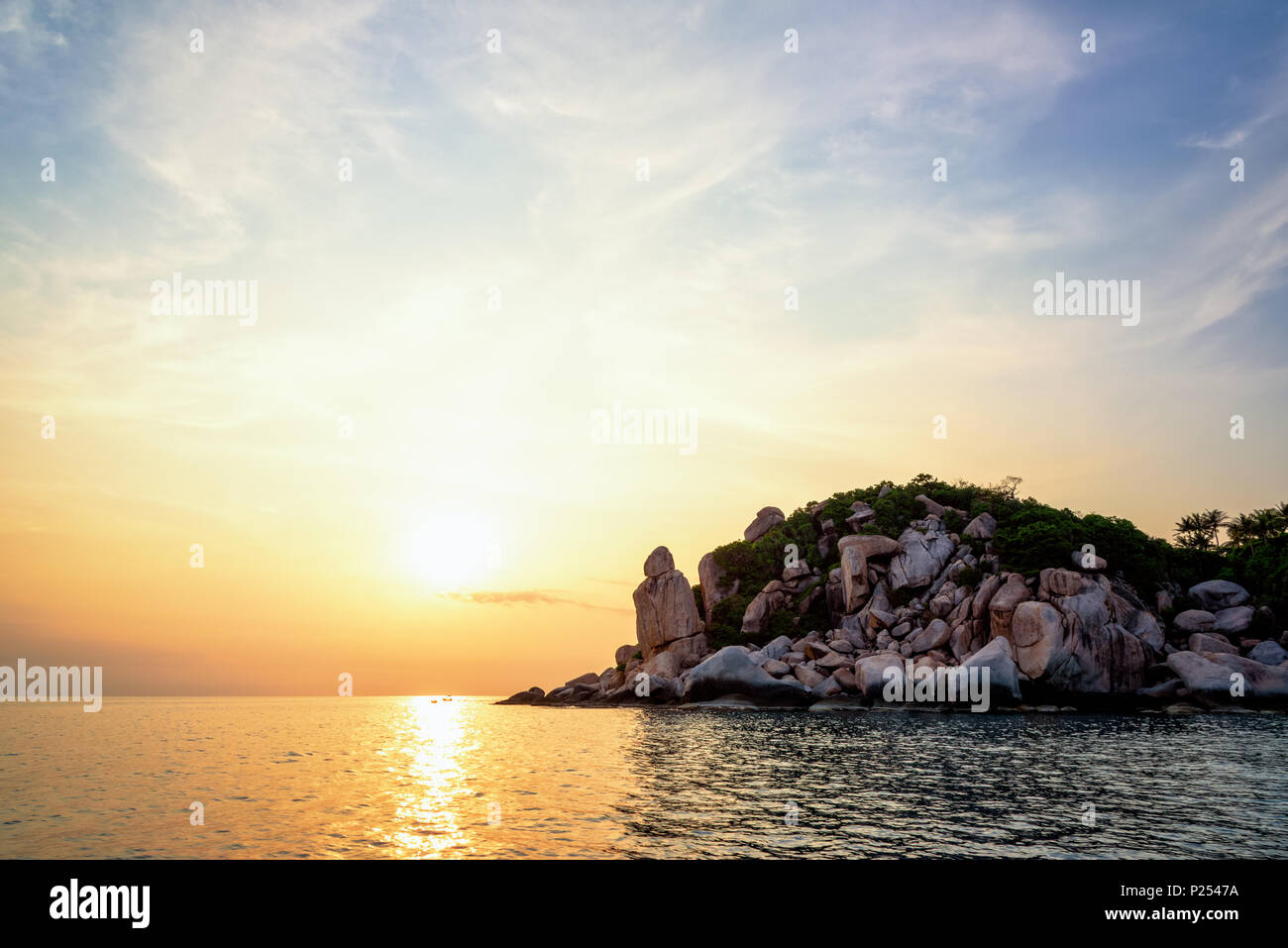 Beautiful nature landscape group strange stone of Buddha Point at cape near John-Suwan viewpoint under the colorful sky and sun during sunset on the s Stock Photo