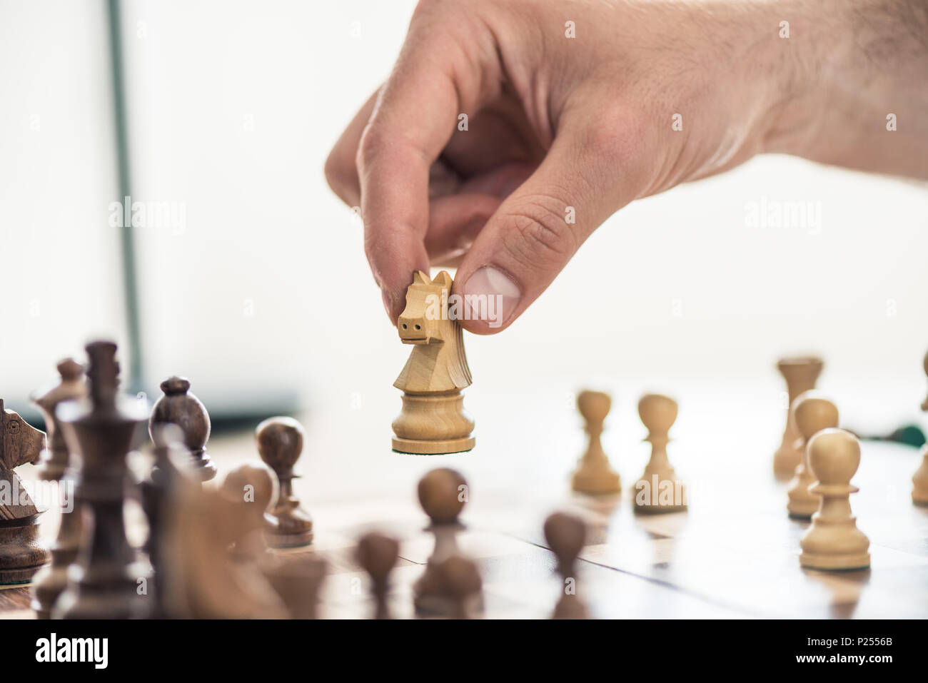 cropped shot of person playing chess, selective focus Stock Photo