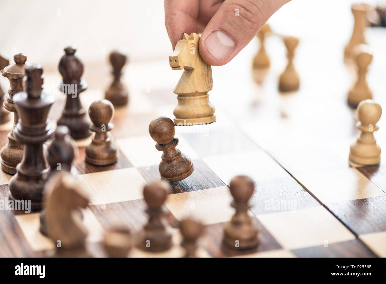 cropped shot of human hand playing chess, selective focus Stock Photo