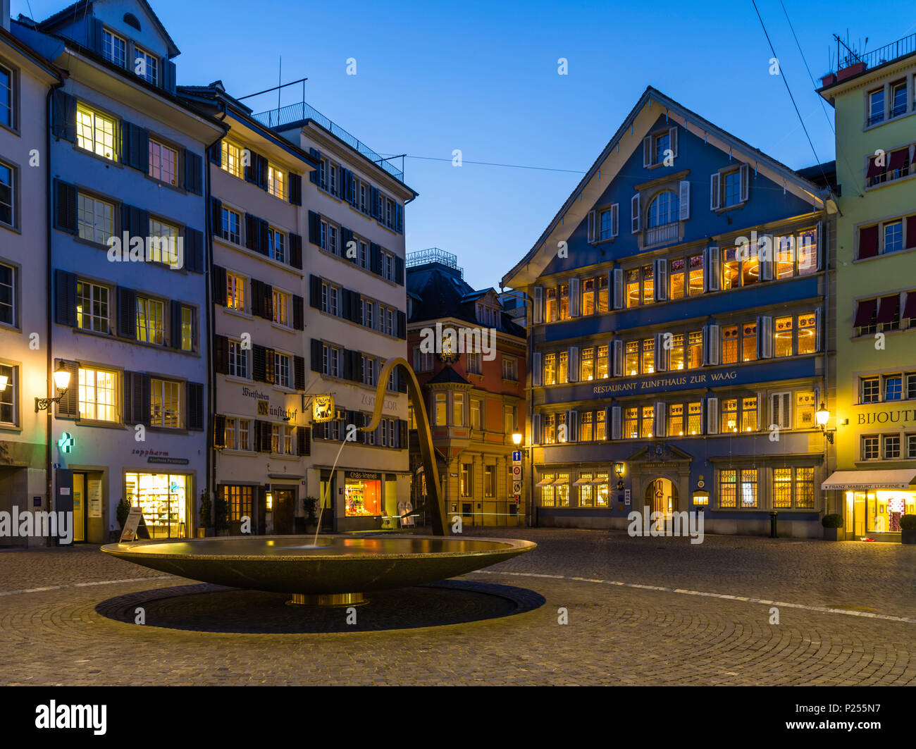 Münsterhof in the Zurich Old Town with guild house to the scales in the evening at the blue hour Stock Photo