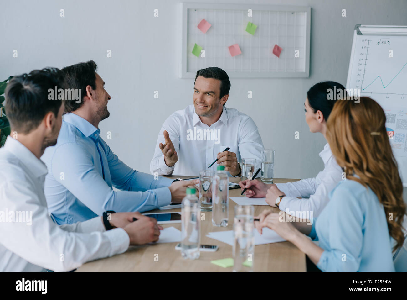 business colleagues having discussion at workplace in office Stock Photo