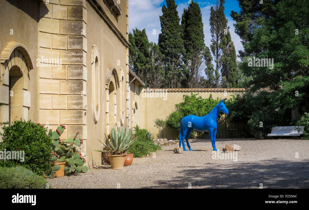 Blue life-size horse statue in a garden Stock Photo