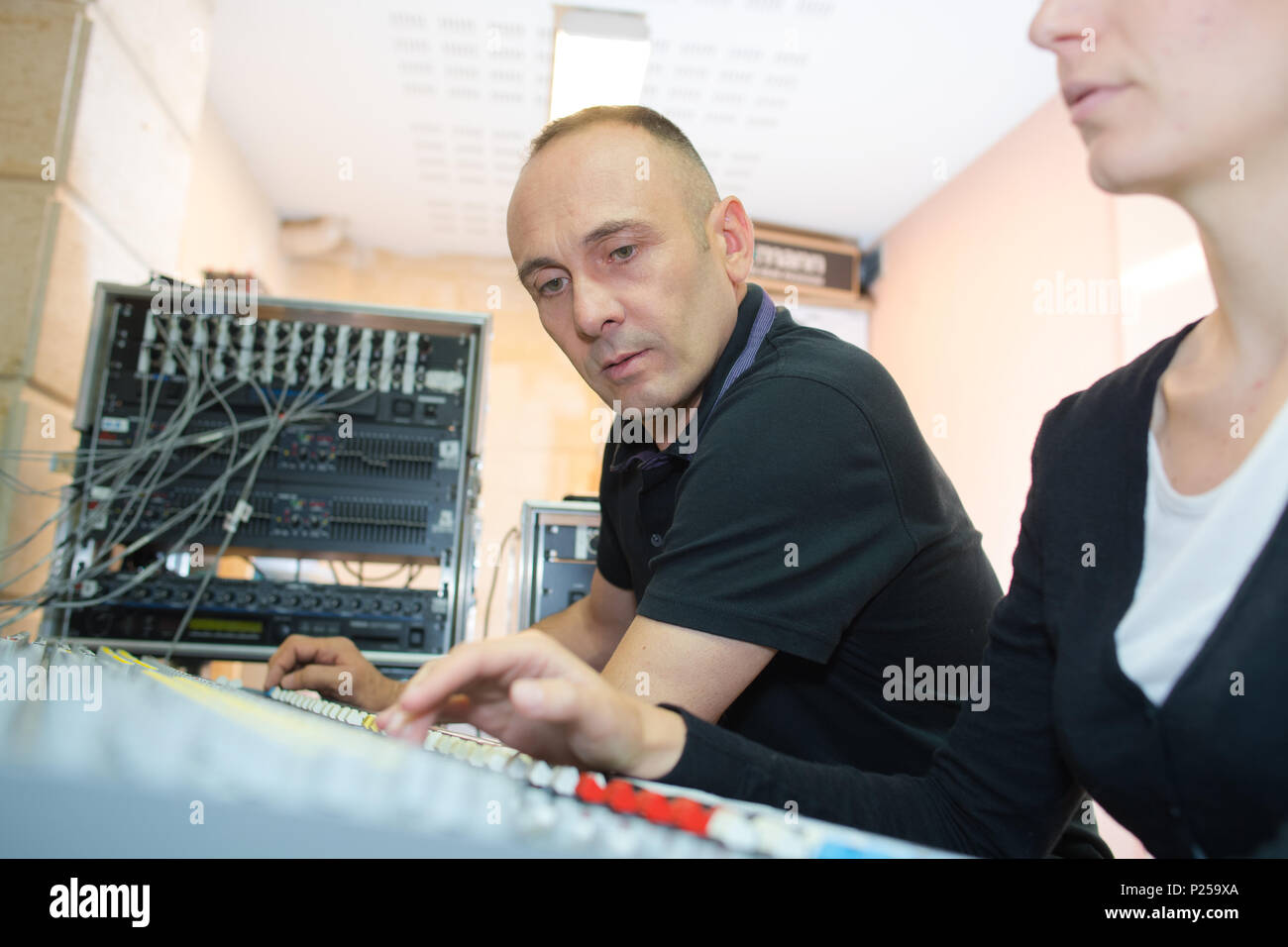 sound engineers working at mixing panel Stock Photo - Alamy