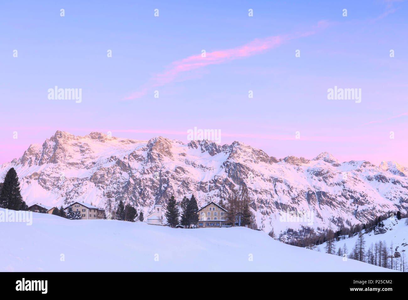 Winter sunrise with white church and houses of the Val Fex, Engadine ...