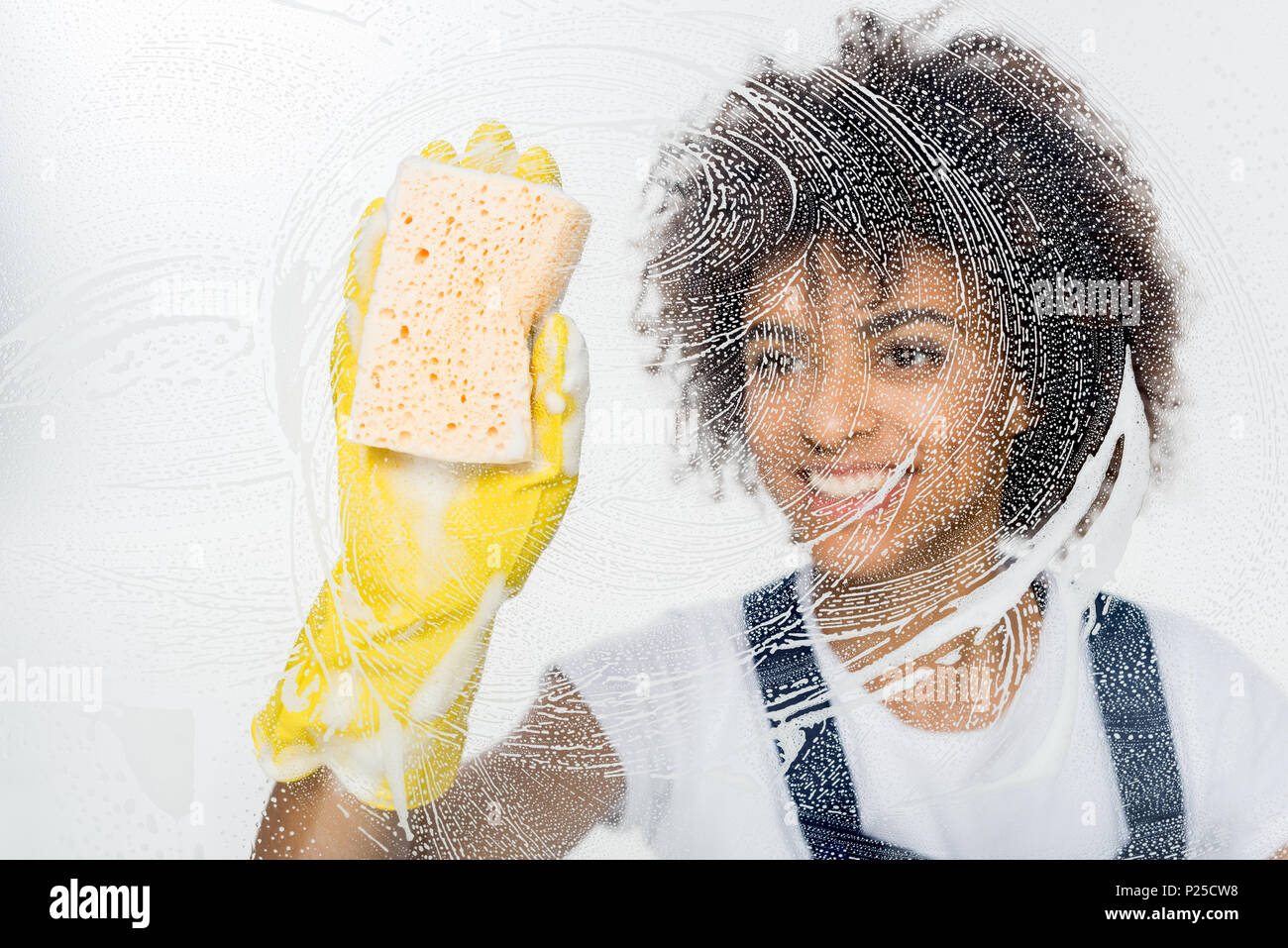 portrait of smiling african american cleaner in rubber gloves cleaning ...