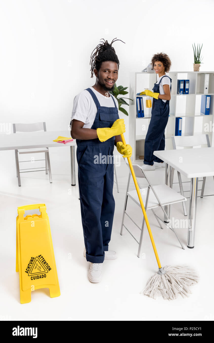 young smiling african american cleaners with cleaning equipment working  together Stock Photo - Alamy