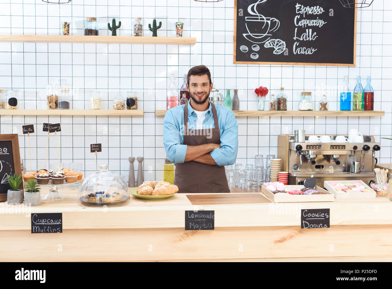 Smiling waiter standing arms hi-res stock photography and images - Alamy