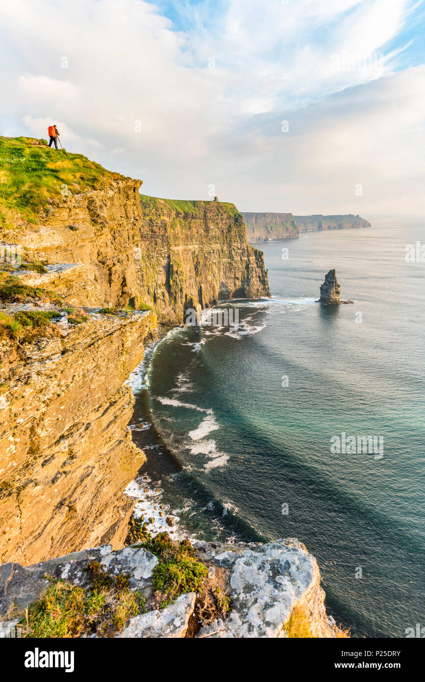 Photographer on the edge of the Cliffs of Moher, Liscannor, Co. Clare, Munster province, Ireland. Stock Photo