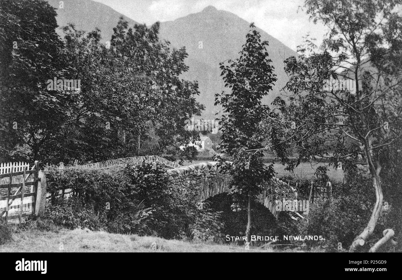 .   This is a photo of listed building number 1144574.  English: Looking south-west over the Grade II listed early 19th-century bridge over Newlands Beck at Stair, in Newlands Valley, Cumbria, England. In the distance is the 2,090 ft. Causey Pike edging Newlands Valley. The photographer was Henry Mayson, who was born in Keswick and who set up a photographic studio there in the 1880s, producing postcards under the 'Mayson Series'. His work concerned the landscape and people of the Lake District. The geog-location is the approximate position of the camera. before 1921. Henry Mayson (1845-1921) b Stock Photo