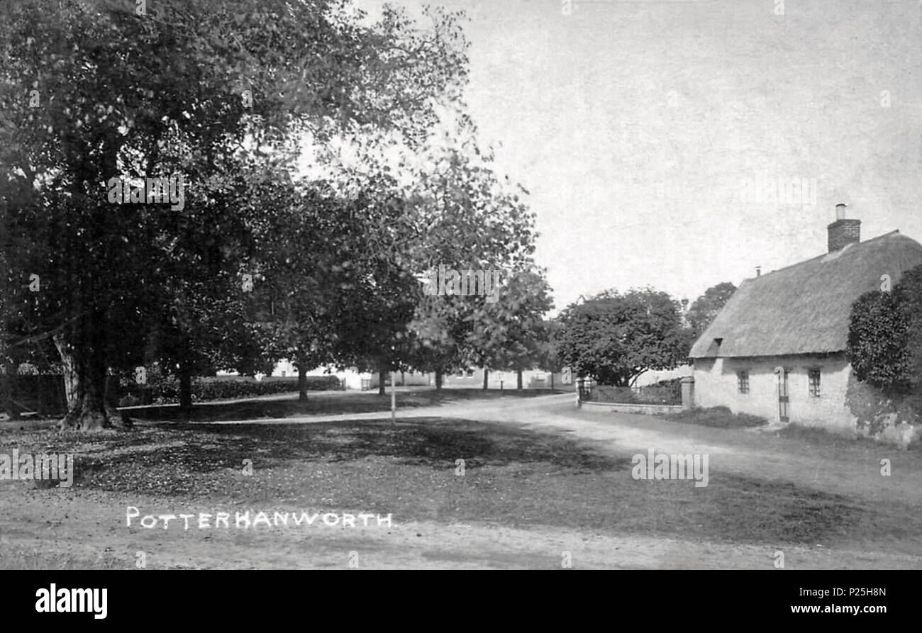 . English: The village green triangle of Potterhanworth, at the junction of today's Nocton Road, Barrf Road, and Moor Lane (or Main Road), in North Kesteven, Lincolnshire, England. Dated 22 December 1909, or before, per card postmark, and as the addition of the First World War monument had yet to be built. A tree (different), still stands on the green. The thatched cottage was demolished; it was replaced by the extended part of the present Potternhanworth CofE Primary School playground. Postcard cropped to remove damaged edges. No indication of author or publisher. 1909 or before. Unknown 232  Stock Photo