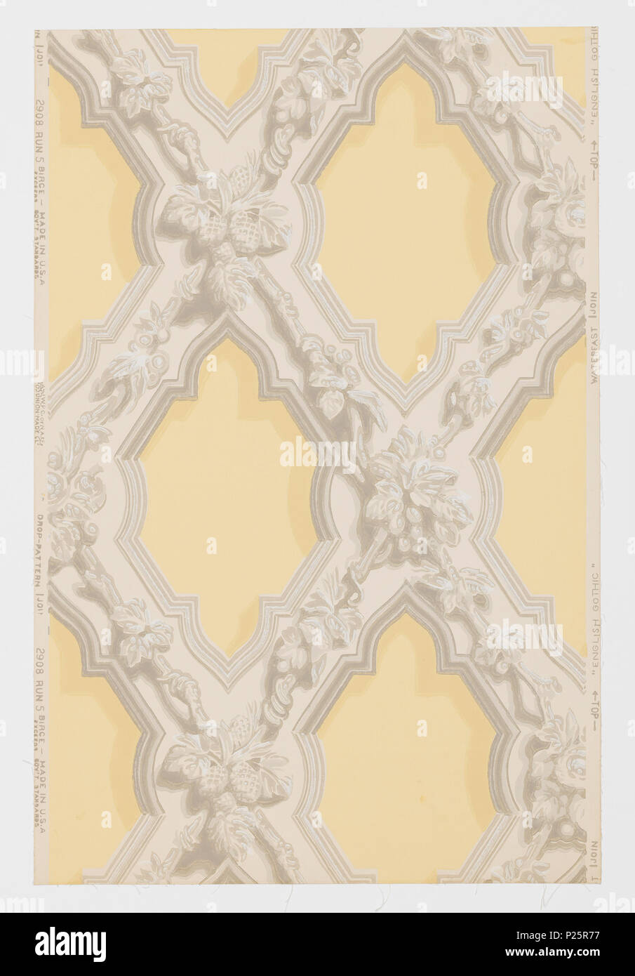 .  English: Sidewall, English Gothic, ca. 1915 .  English: Representing ornamental plaster form of decoration in English Gothic used in the first half of the 19th century. Composed of criss-crossing wide bands ornamented with leaves, flowers, nuts and fruits. Bands are edged with simulated moldings. A reproduction of an old wallpaper from the walls of the front entry of John Sible's house, Hancock Street, Salem, Massachusetts. It was put on walls in 1858. Printed on reverse side: 'No. 295 CB'. Printed in grisaille on pale gold field. Not original colors. . circa 1915 292 Sidewall, English Goth Stock Photo