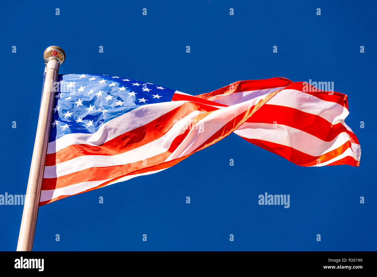 American Flag against blue sky Stock Photo - Alamy