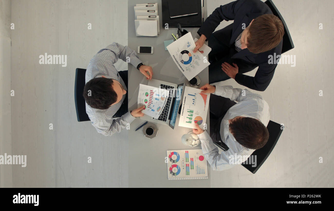 Creative team displaying charts with laptop and tablet pc computers ...