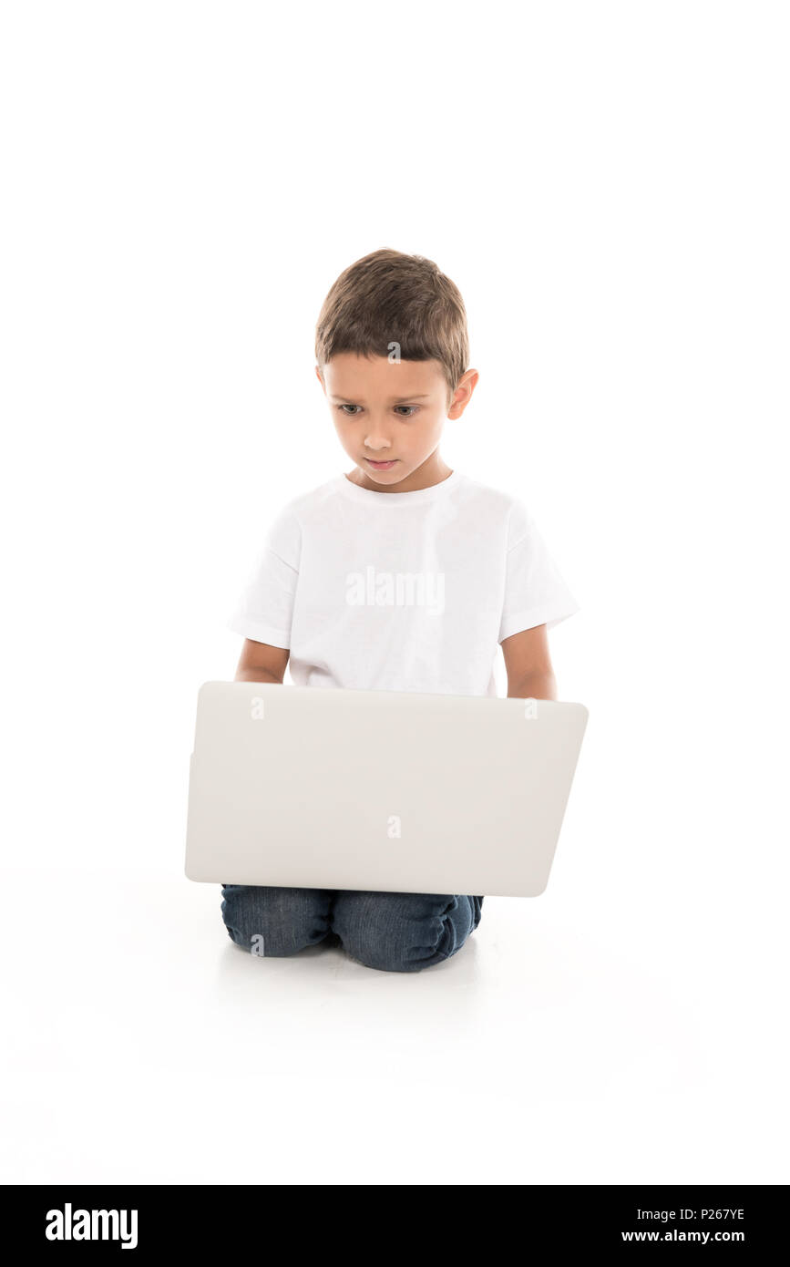 focused little boy using laptop isolated on white Stock Photo - Alamy