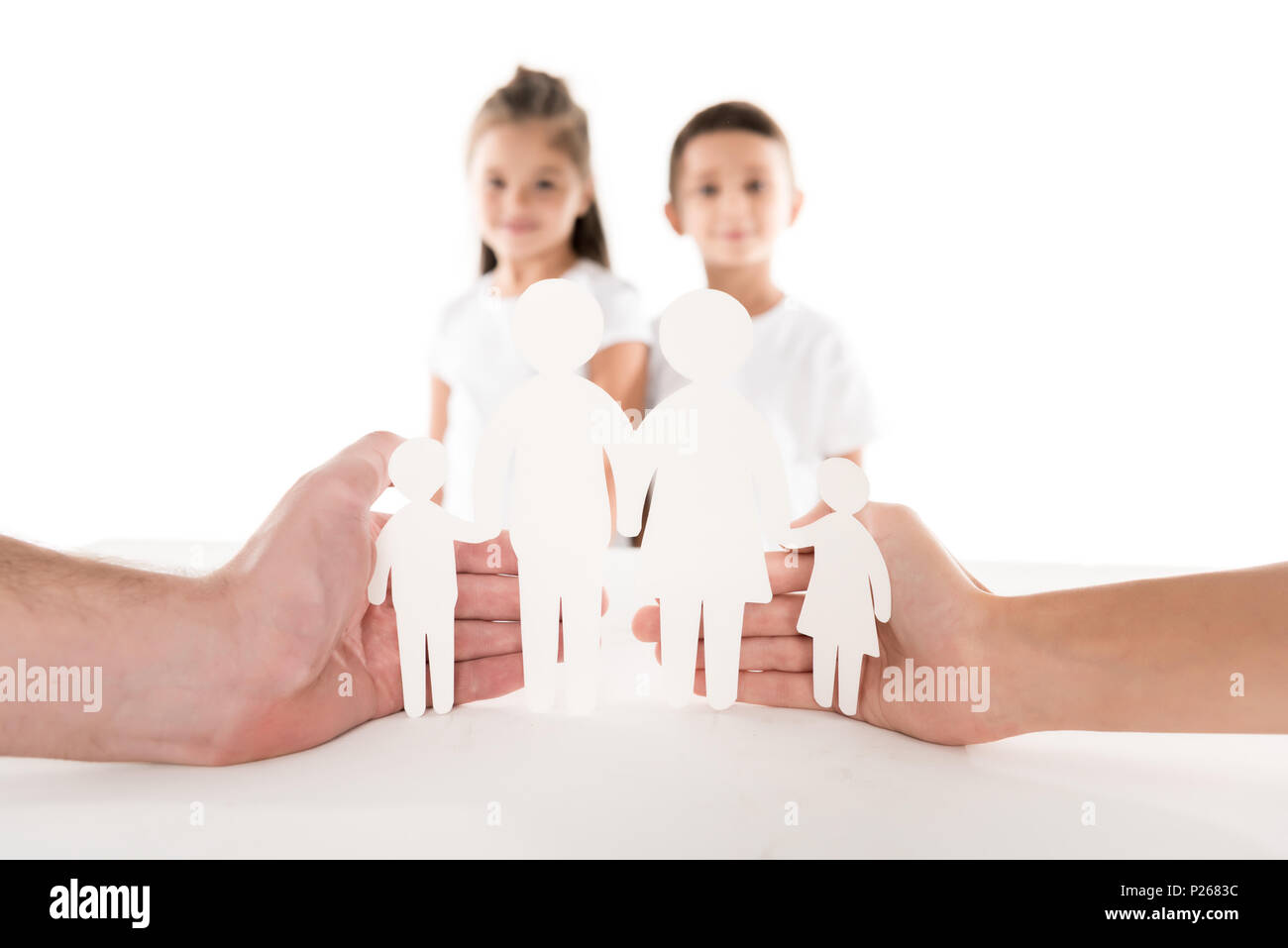 Paper family in parents hands with kids standing behind, isolated on ...