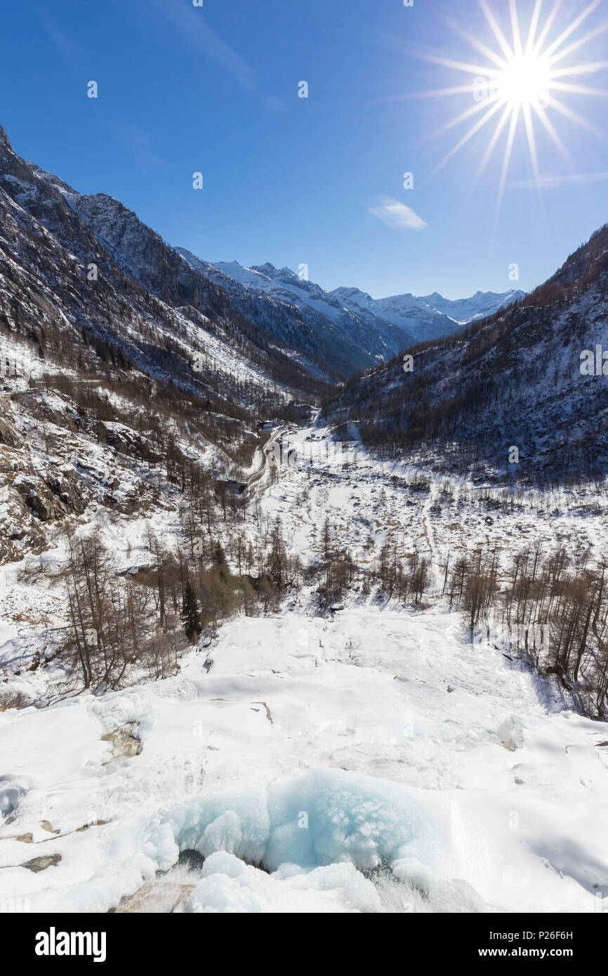 View of the frozen Cascata del Toce waterfall in winter. Frua hamlet, Formazza, Valle Formazza, Verbano Cusio Ossola, Piedmont, Italy. Stock Photo