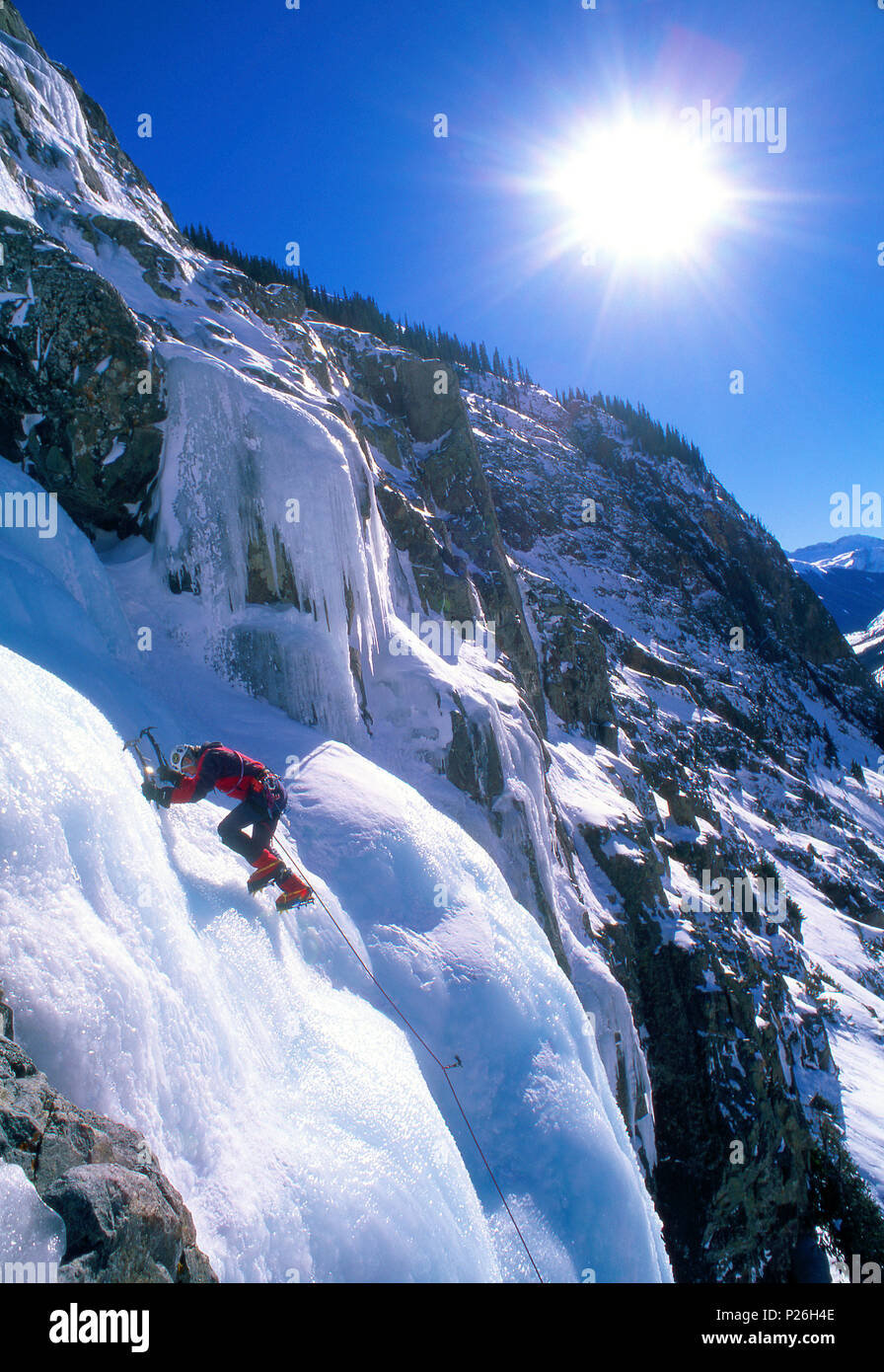 male ice climber climbing "Stairway to Heaven" in Colorado Stock Photo